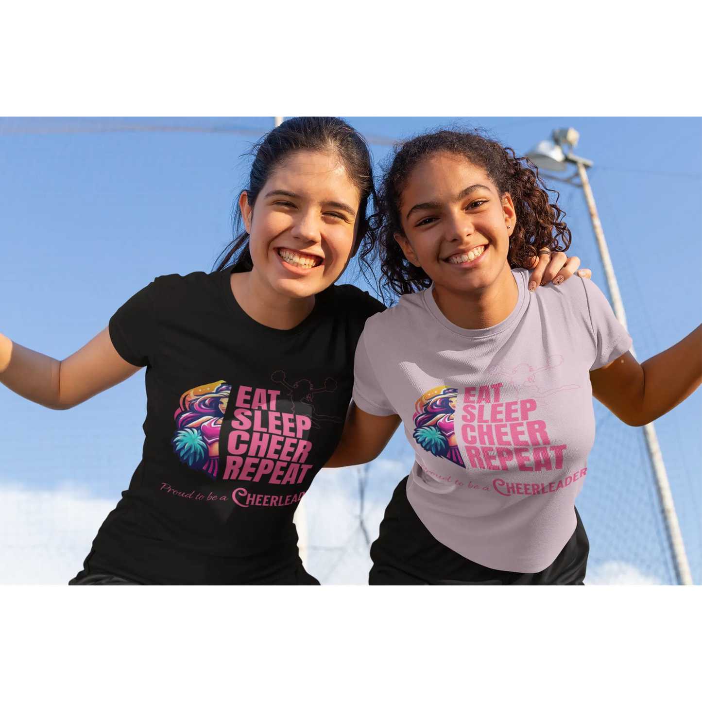 Cheerleader wearing black t-shirt and another cheerleader in a light pink t-shirt both with 'Eat Sleep Cheer Repeat' cheerleading design