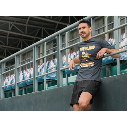 Male Cheerleading coach wearing a black t-shirt with a cheerleading graphic design on a football field