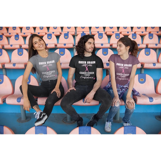 Three cheerleading coaches  sitting on bleachers wearing cheerleader themed t-shirts.