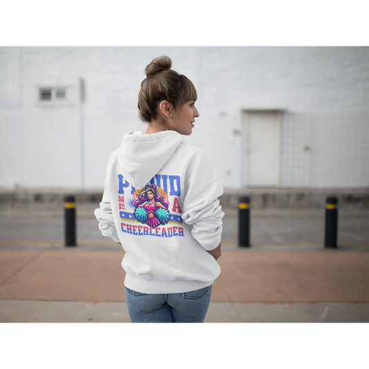 Cheerleading coach wearing a white hoodie with colourful cheerleading graphics and text, standing outdoors.