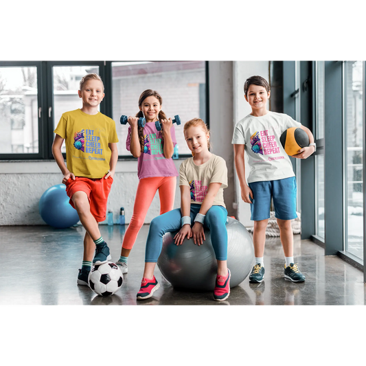 Four children in a gym setting with exercise balls and sports equipment wearing a cheerleading themed t-shirt